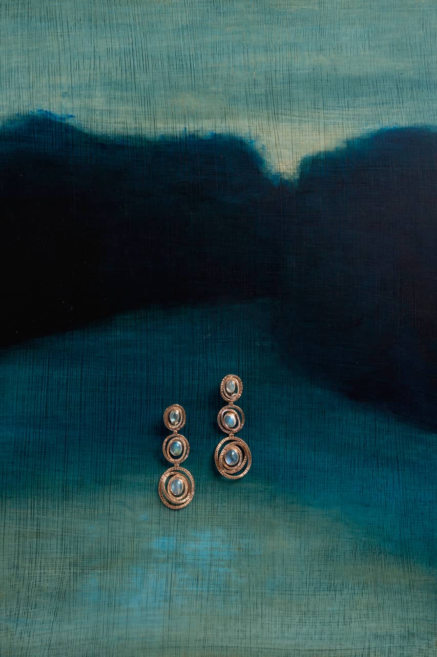 Maud Earrings on a blue background